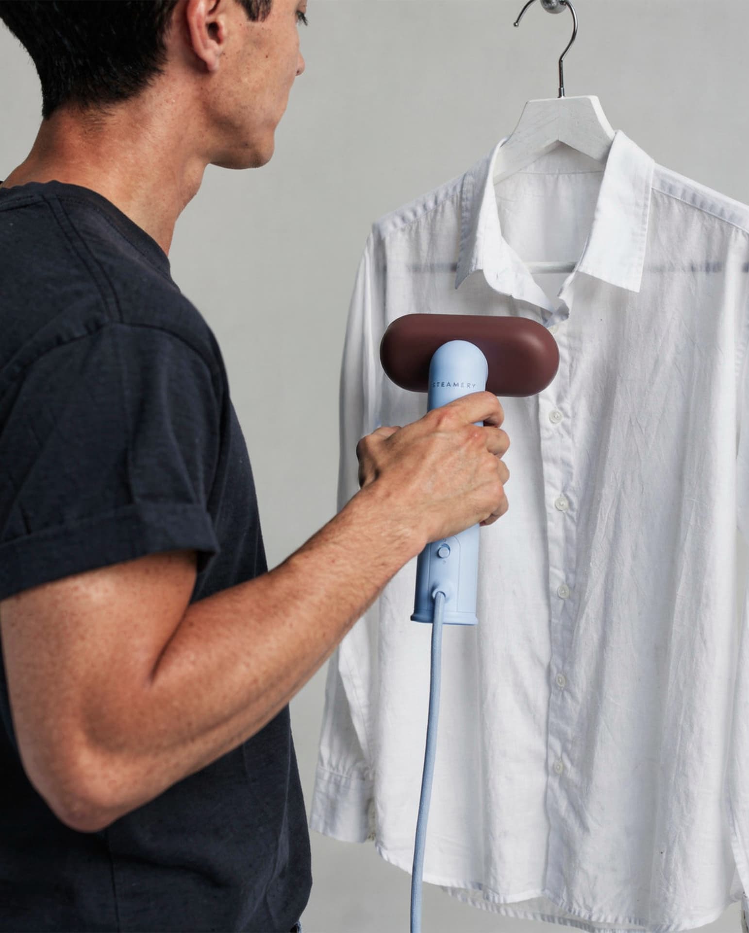 AI-generated character steaming a white linen shirt on a hanger