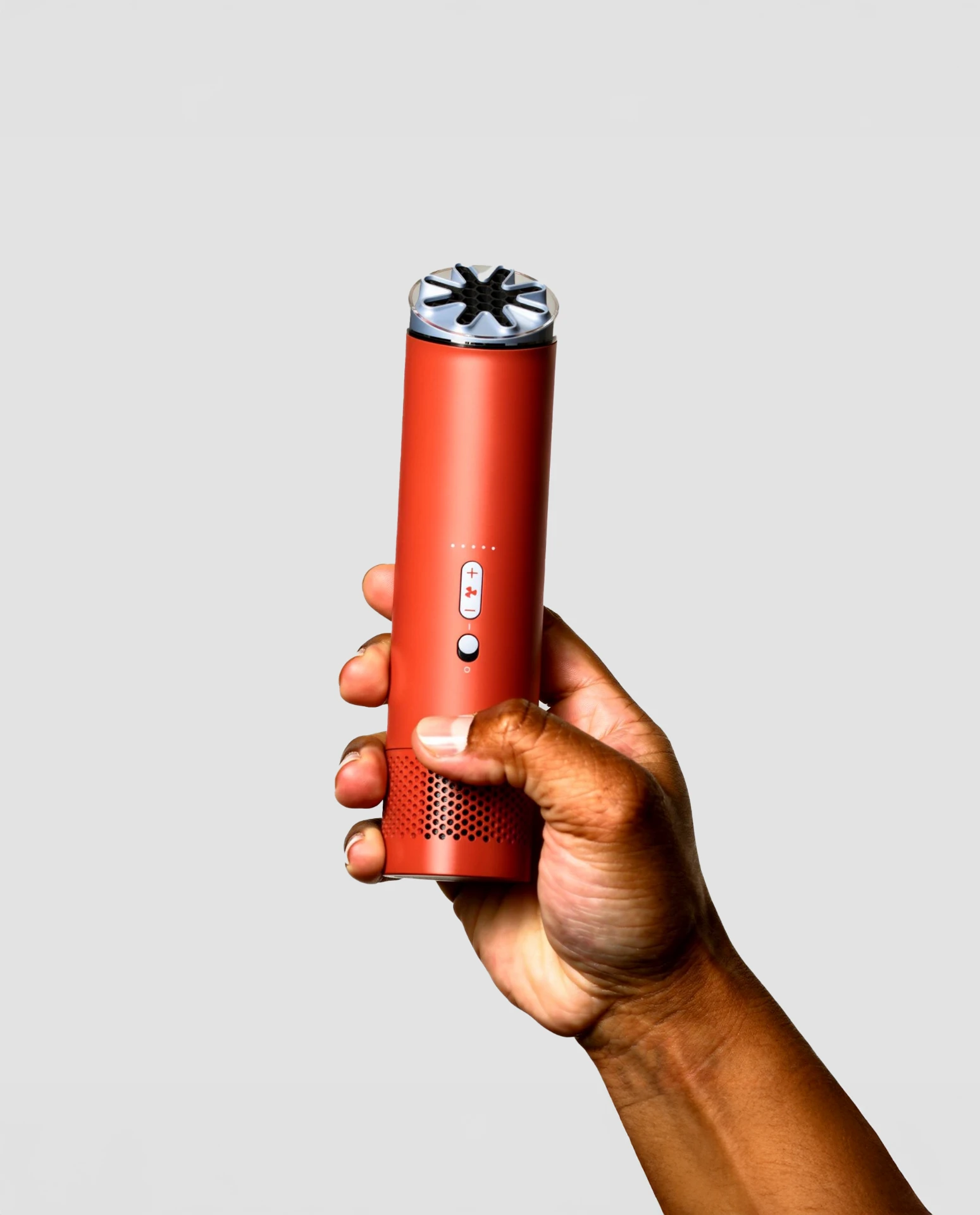 AI-generated hand holding a red cylindrical device against a light backdrop